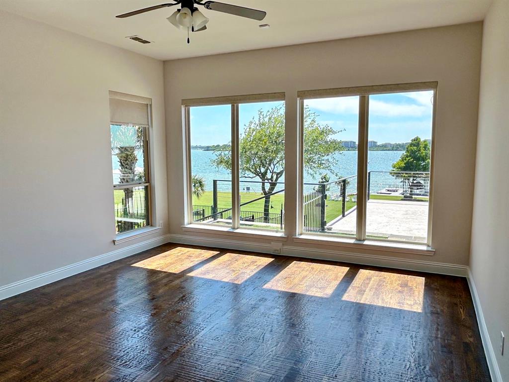 2313 Windjammer Way Rowlett, TX 75088 - Photo 18 of 38 a view of an empty room with wooden floor and a window