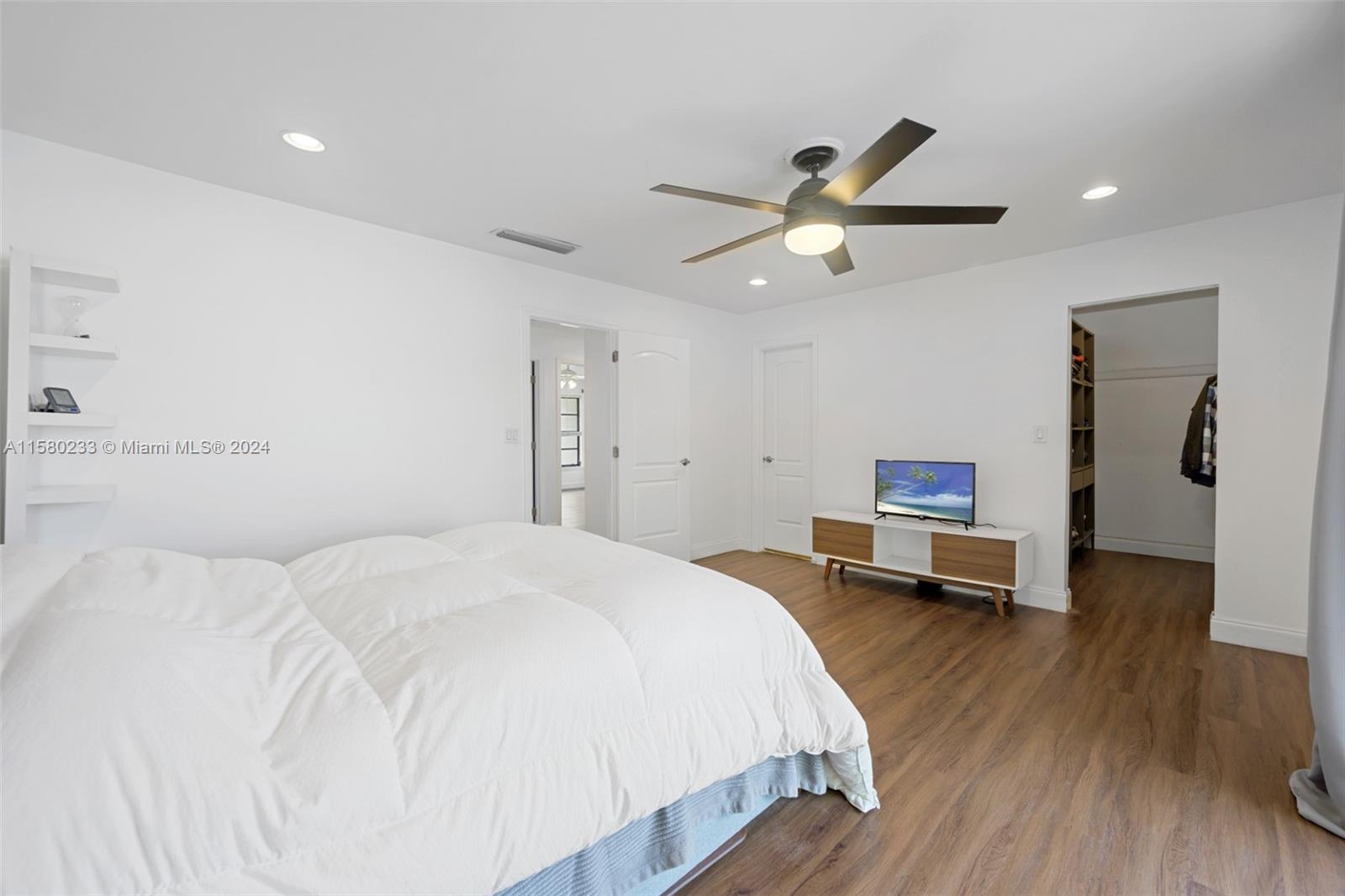 Emerald Hills Hollywood, FL 33021 - Photo 12 of 25 a bedroom with a bed and a chandelier