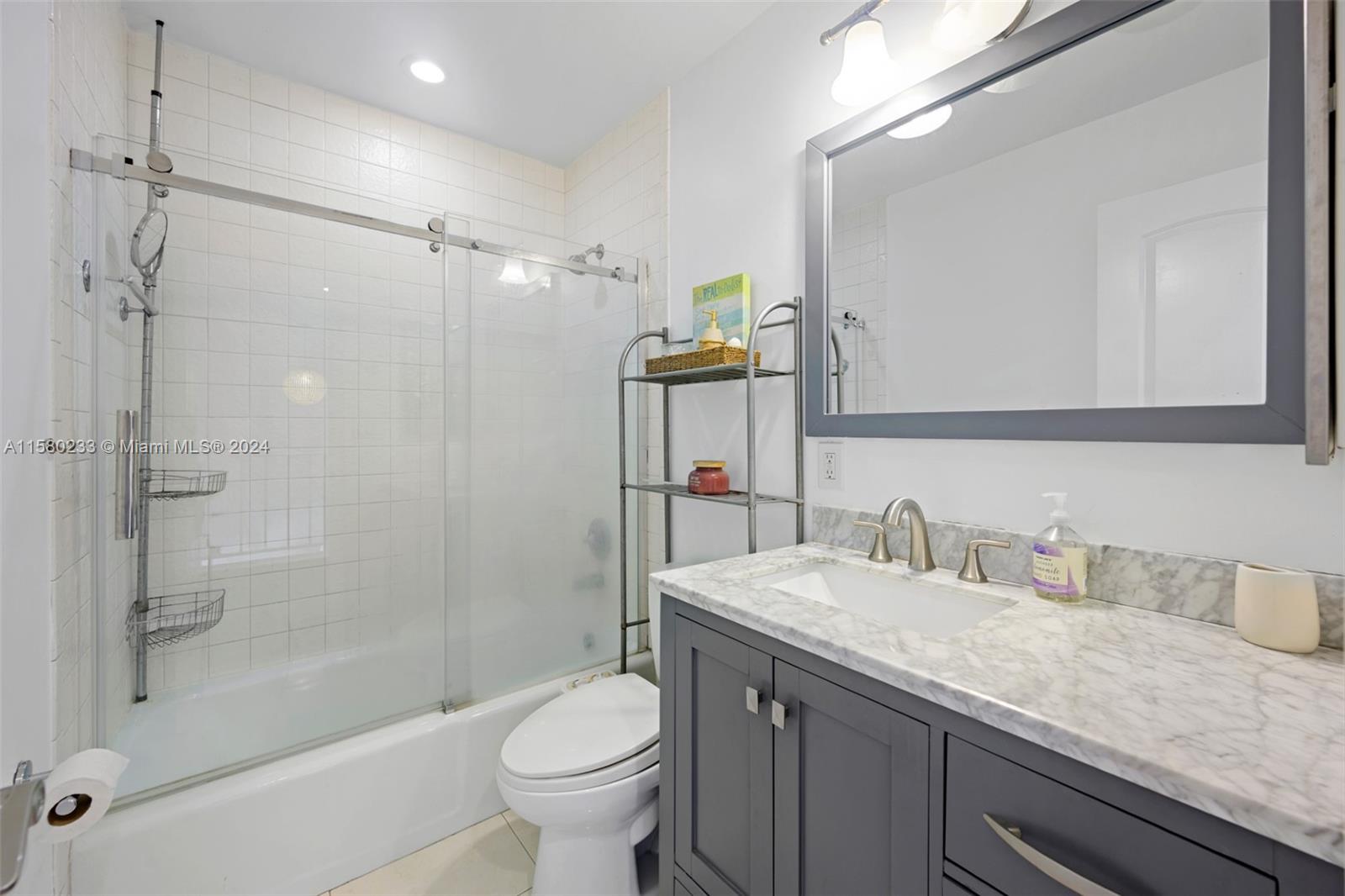 Emerald Hills Hollywood, FL 33021 - Photo 13 of 25 a bathroom with a granite countertop sink toilet and shower
