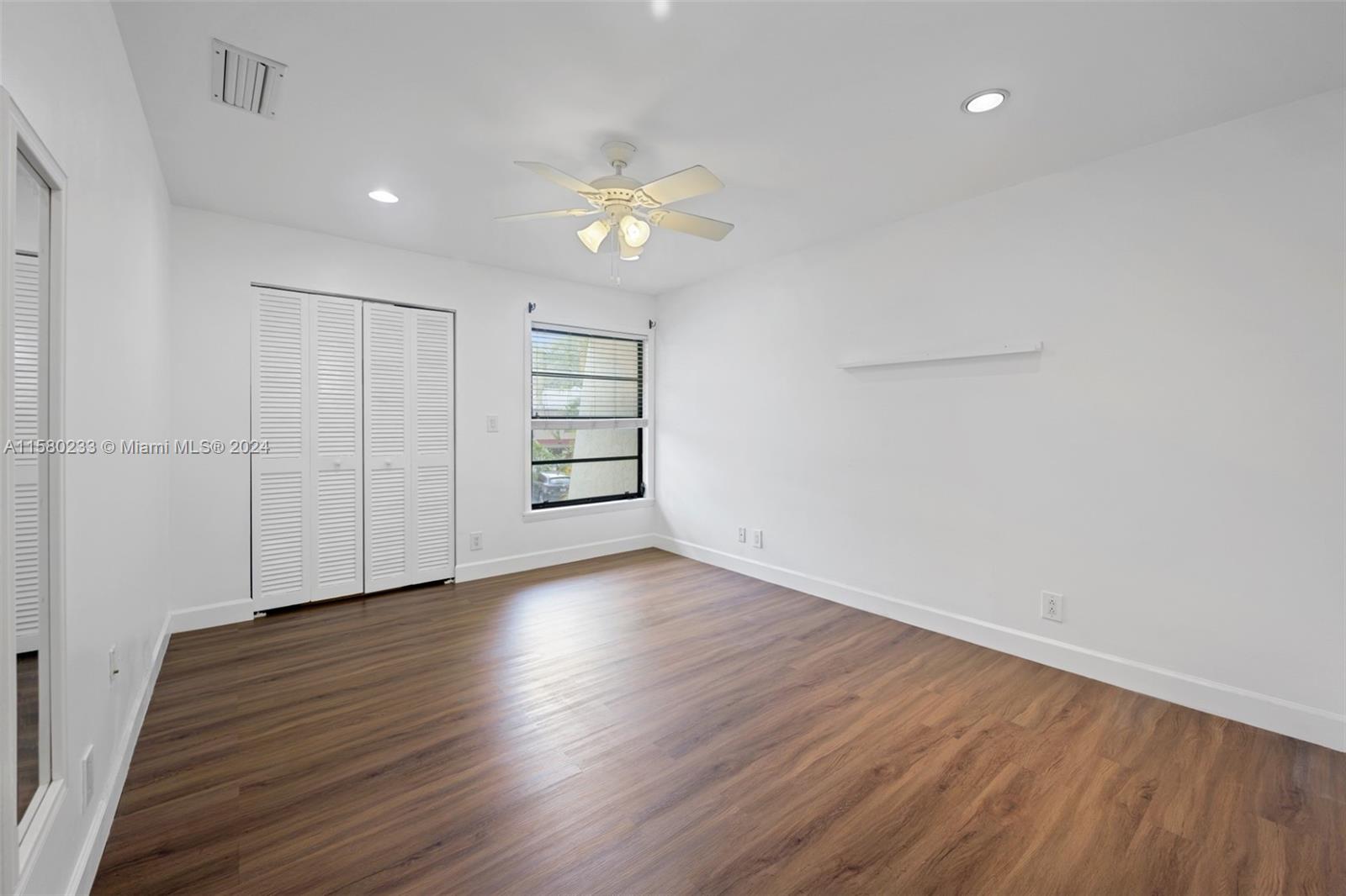 Emerald Hills Hollywood, FL 33021 - Photo 18 of 25 an empty room with wooden floor closet and windows