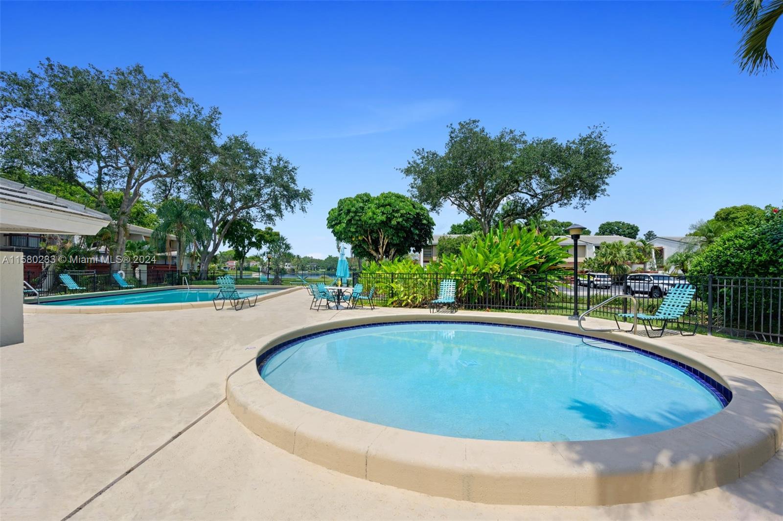 Emerald Hills Hollywood, FL 33021 - Photo 2 of 25 a view of a swimming pool and trees in the background