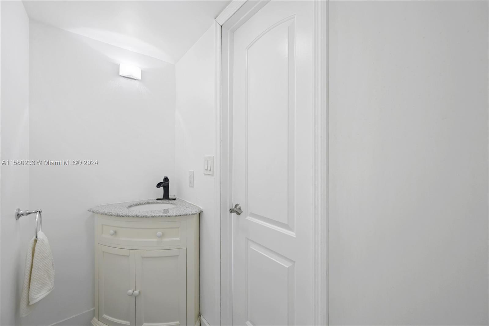 Emerald Hills Hollywood, FL 33021 - Photo 21 of 25 a bathroom with a sink and vanity