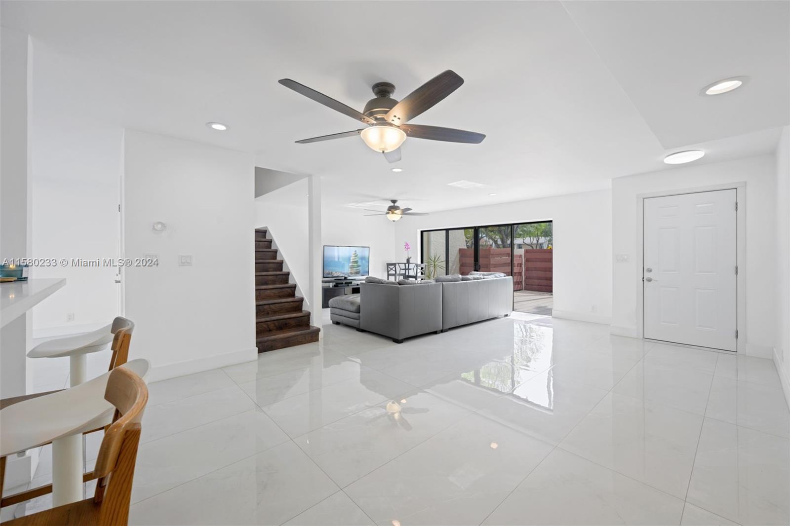 Emerald Hills Hollywood, FL 33021 - Photo 5 of 25 a living room with furniture and a ceiling fan