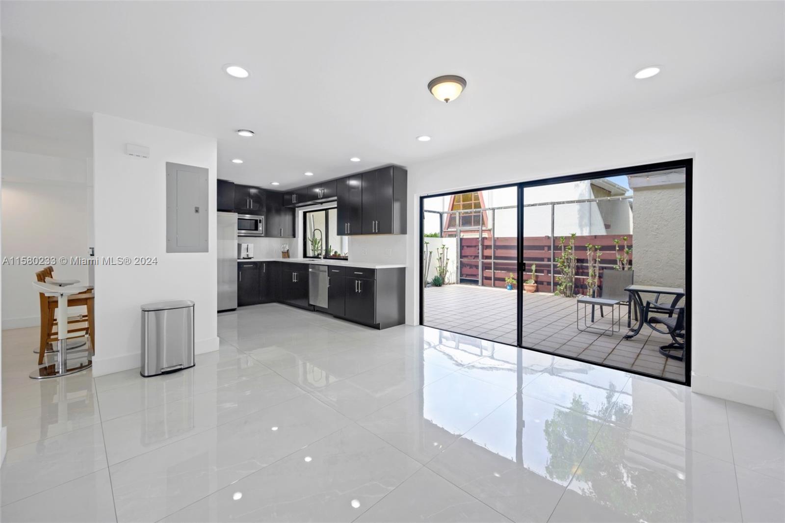 Emerald Hills Hollywood, FL 33021 - Photo 8 of 25 a large white kitchen with a large window