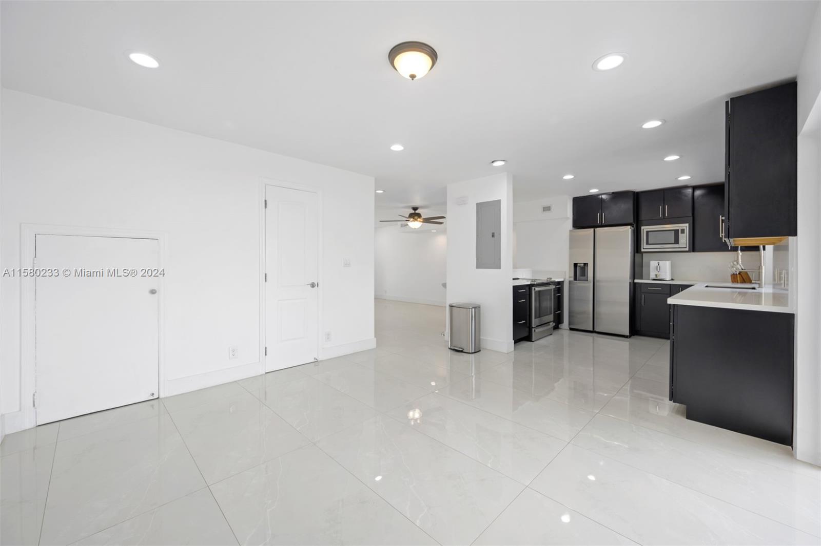 Emerald Hills Hollywood, FL 33021 - Photo 9 of 25 a view of kitchen with refrigerator and microwave