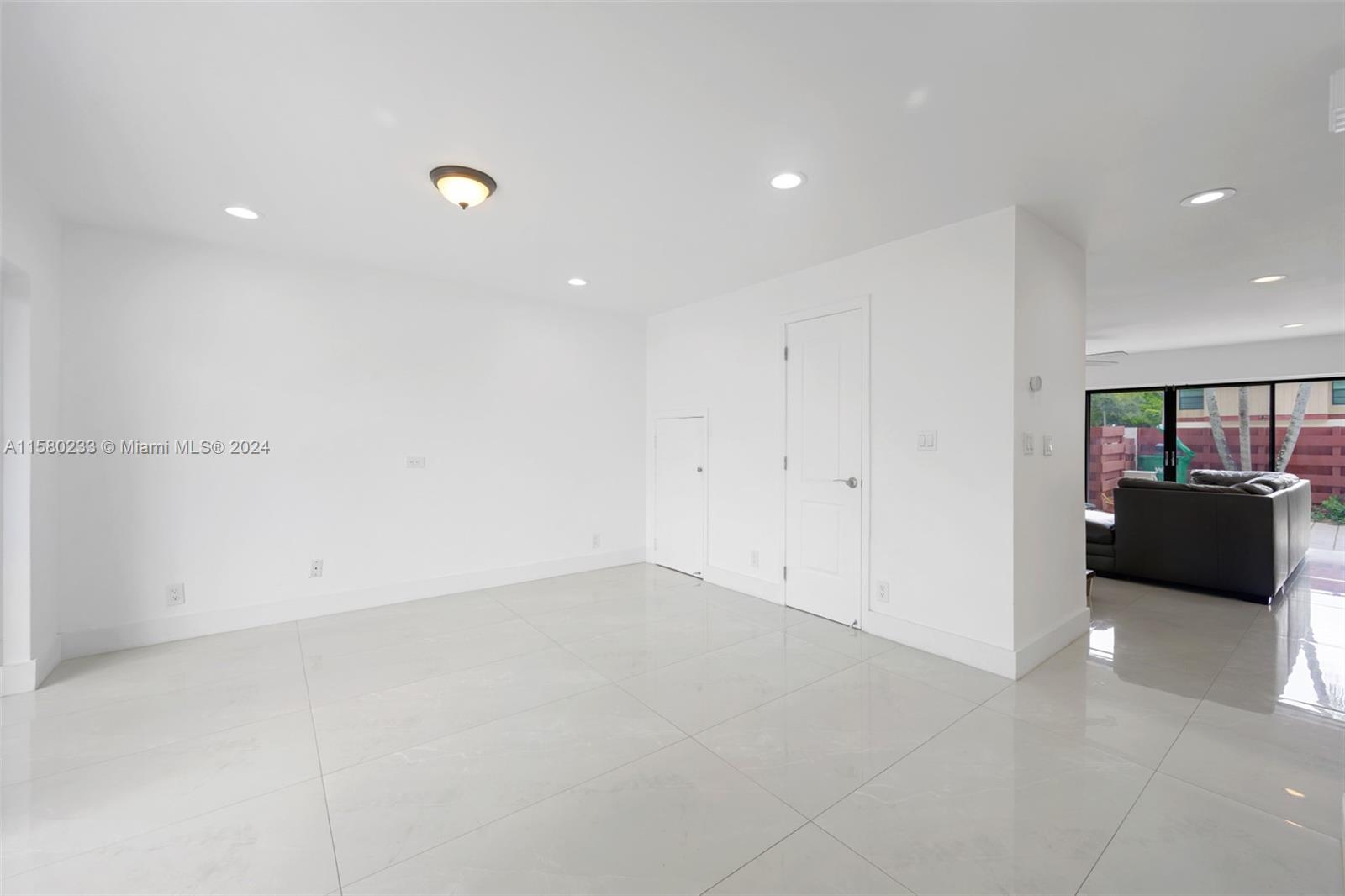 Emerald Hills Hollywood, FL 33021 - Photo 10 of 25 an empty room with a refrigerator and mirror