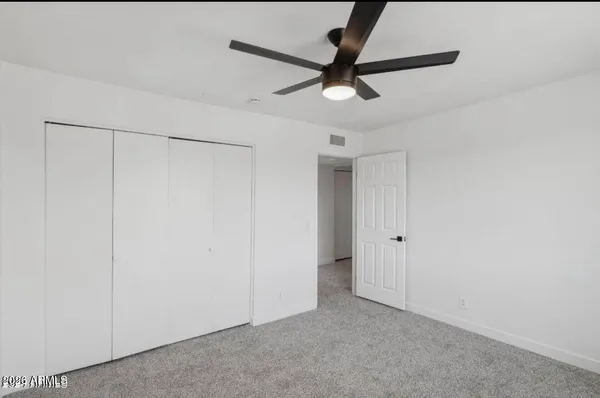 a view of a room with a ceiling fan