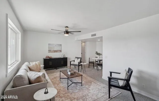 a living room with furniture and a window