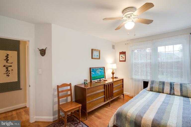 7035 Heathfield Road Baltimore, MD 21212 - Photo 22 of 26 a bed room with a bed and a chandelier