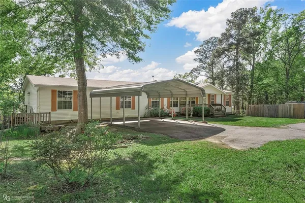 a front view of a house with yard and green space
