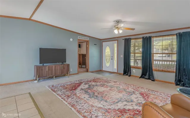 a spacious bedroom with a large bed and a flat screen tv