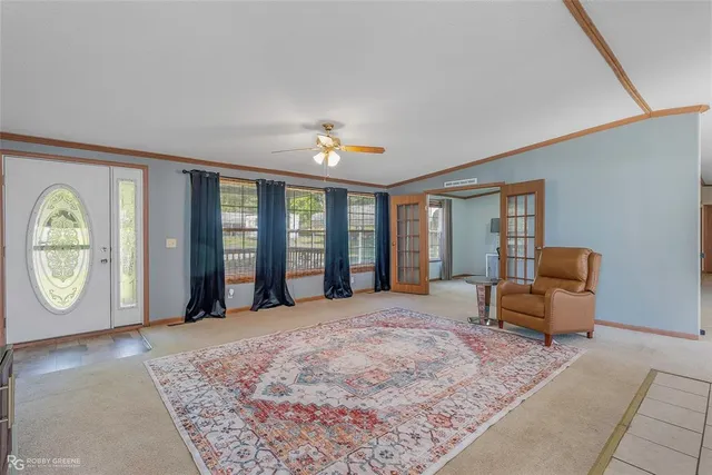 a large bedroom with a bed and a large window