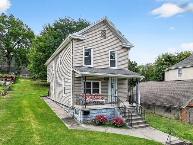 a front view of house with yard and green space