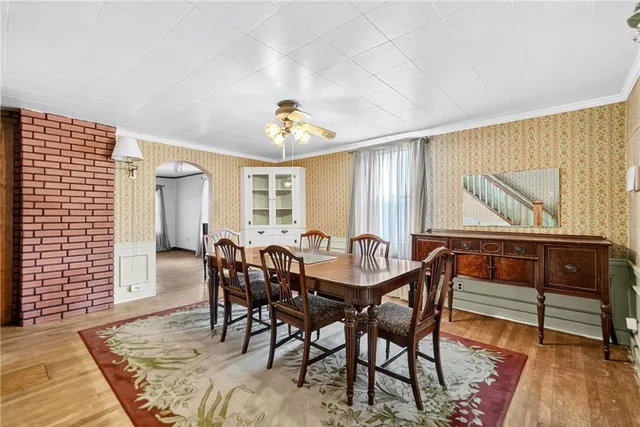 a view of a dining room with furniture and wooden floor