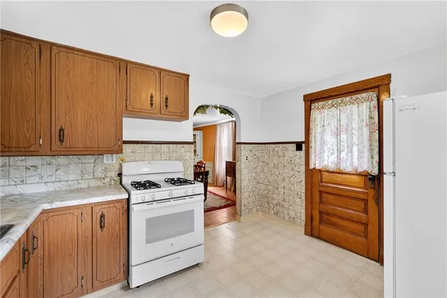 a kitchen with cabinets appliances and a window