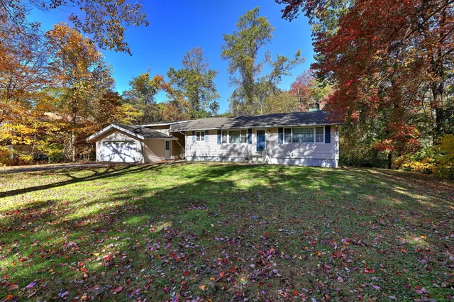 a view of a house with backyard and sitting area