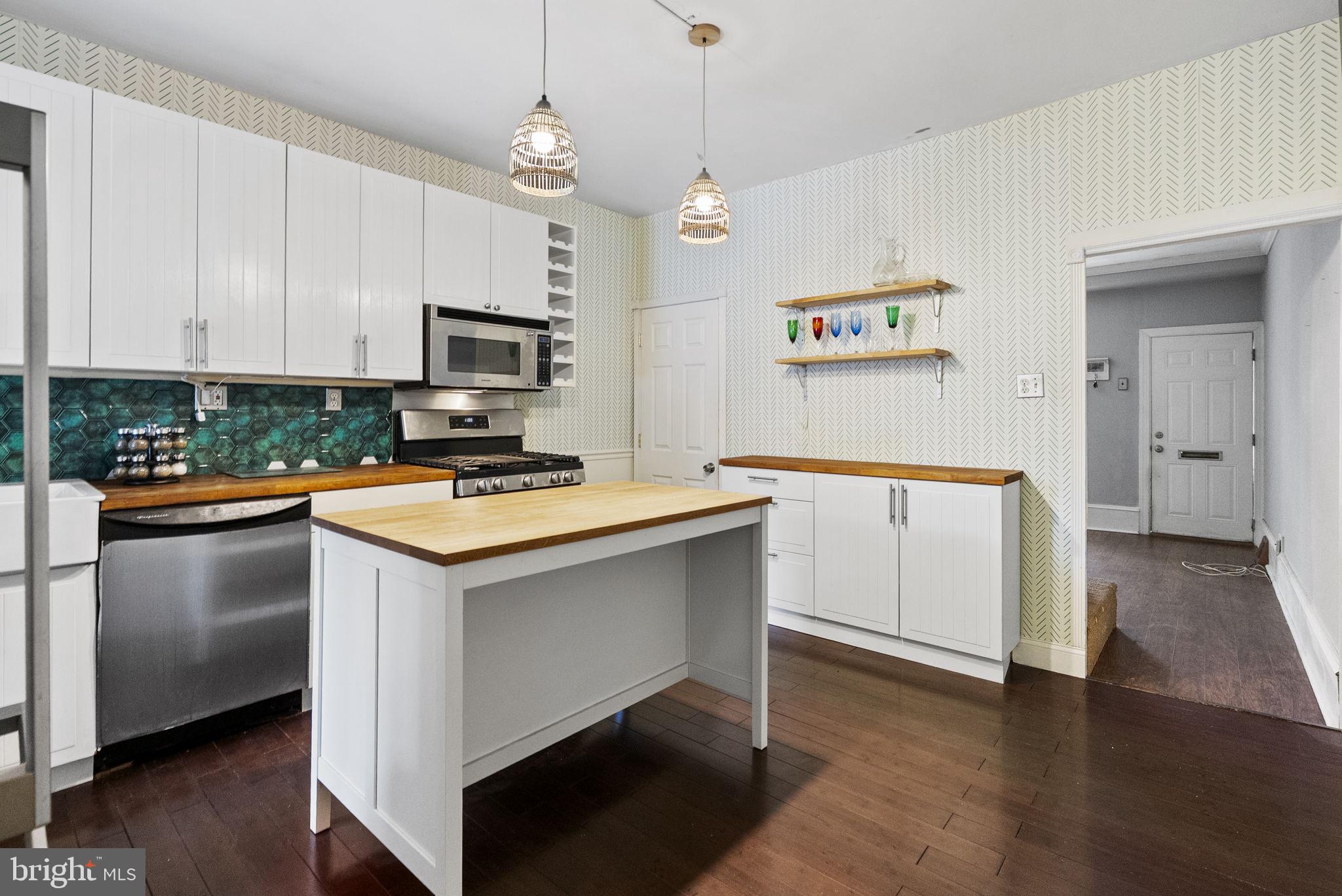 4349 Terrace Street Philadelphia, PA 19128 - Photo 13 of 25 a kitchen with granite countertop a stove a sink and a refrigerator