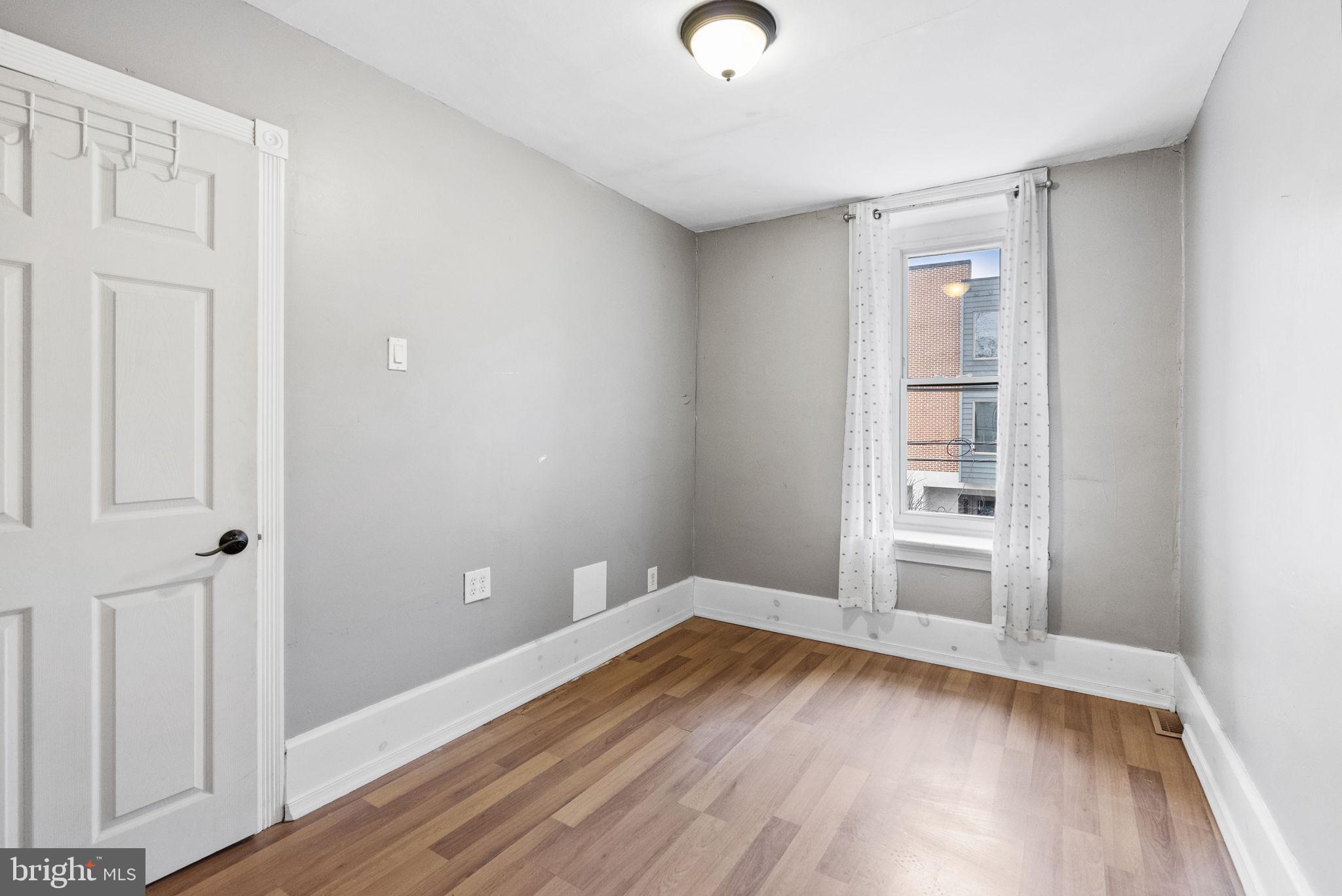 4349 Terrace Street Philadelphia, PA 19128 - Photo 18 of 25 an empty room with wooden floor and windows