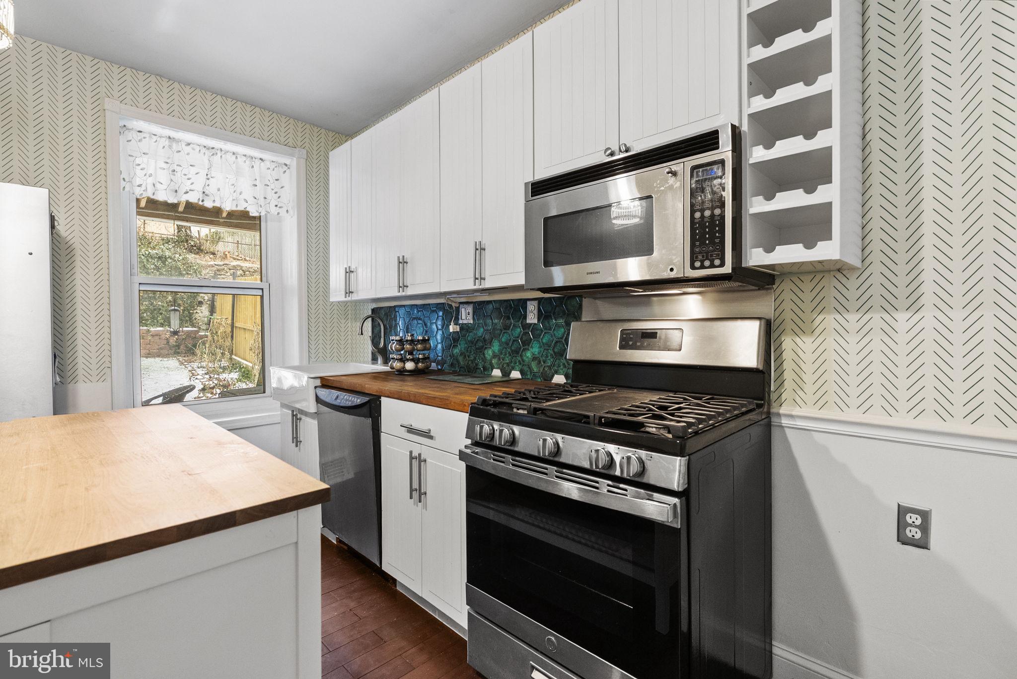 4349 Terrace Street Philadelphia, PA 19128 - Photo 9 of 25 a kitchen with stainless steel appliances a stove microwave and stove
