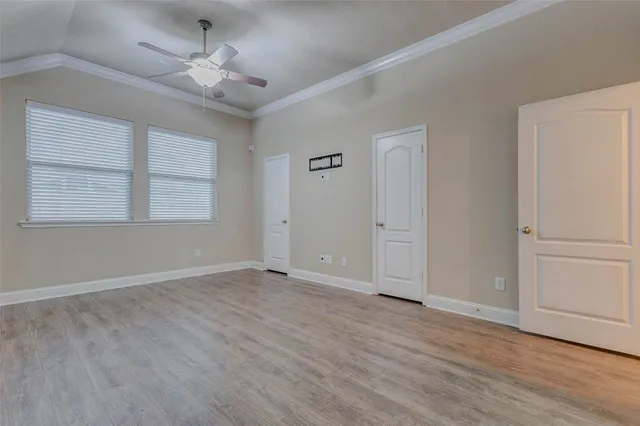 a view of an empty room with wooden floor