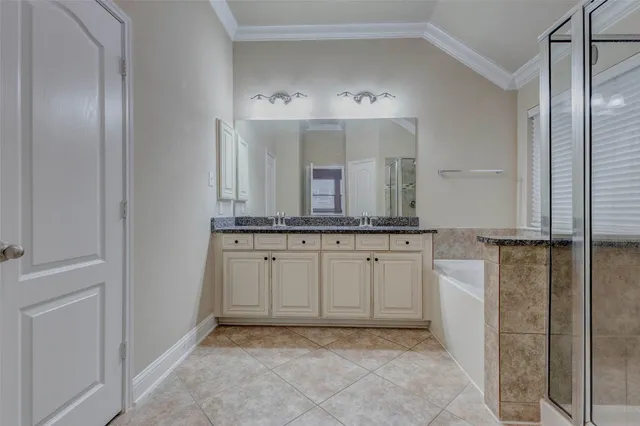 a bathroom with a granite countertop sink a toilet and shower