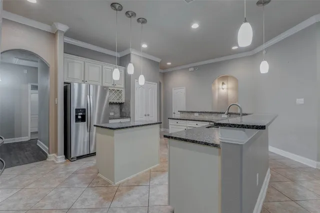 a kitchen with stainless steel appliances granite countertop a refrigerator and a sink