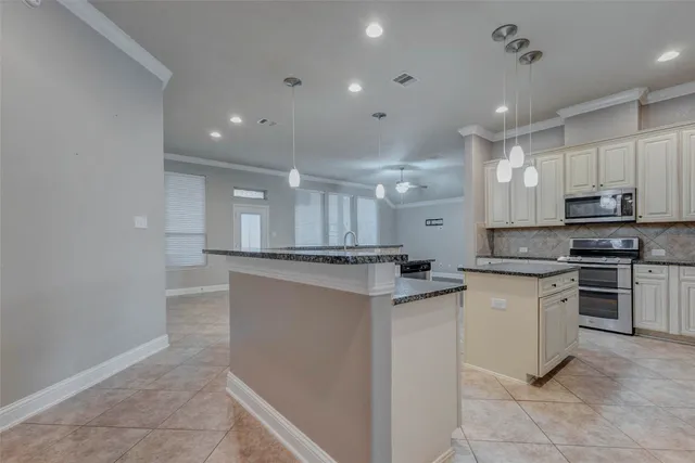 a kitchen with stainless steel appliances granite countertop a sink and cabinets