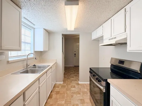 a kitchen that has a sink and a stove
