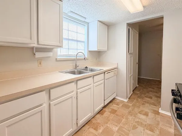 a kitchen with a sink and cabinets