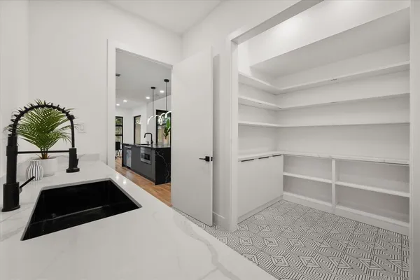 a hallway with a couch and a large window