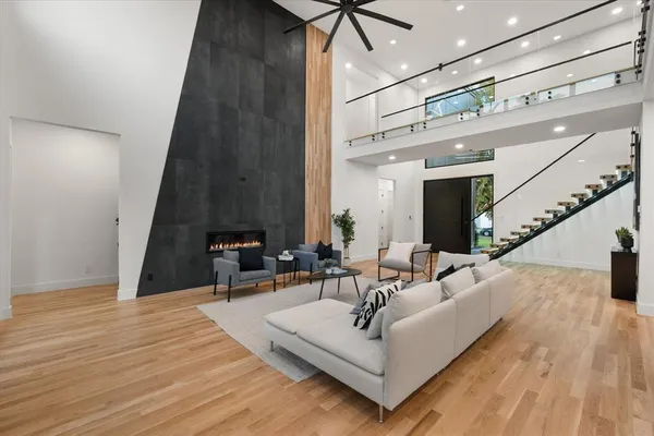 a living room with furniture and a wooden floor