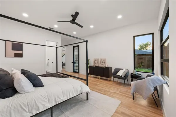 a bedroom with furniture and a large window