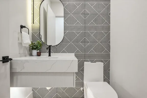 a white toilet sitting next to a bathroom sink