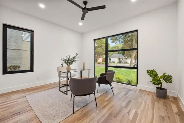 a living room with furniture and a potted plant