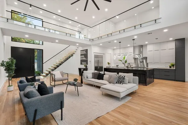 a living room with furniture and kitchen view