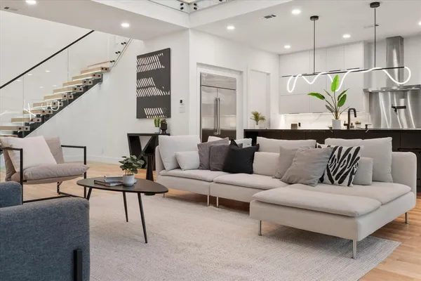 a living room with furniture and a chandelier