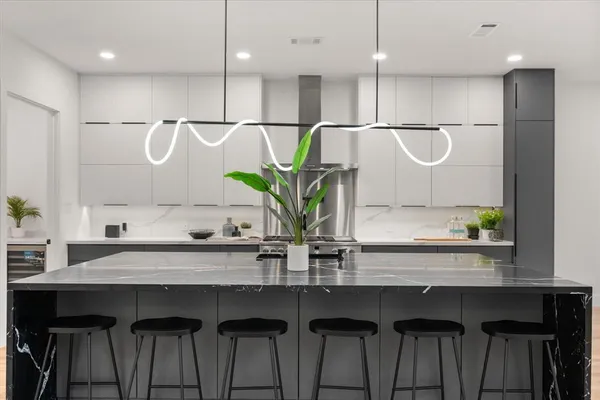 a kitchen with a table chairs refrigerator and cabinets