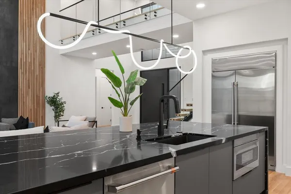 a kitchen with a sink and a mirror