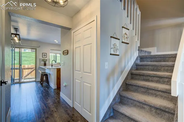 a view of entryway and hall with wooden floor