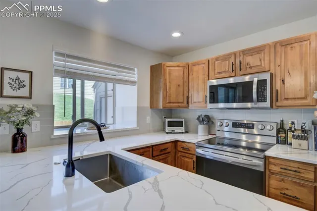 a kitchen with a sink a counter and cabinets