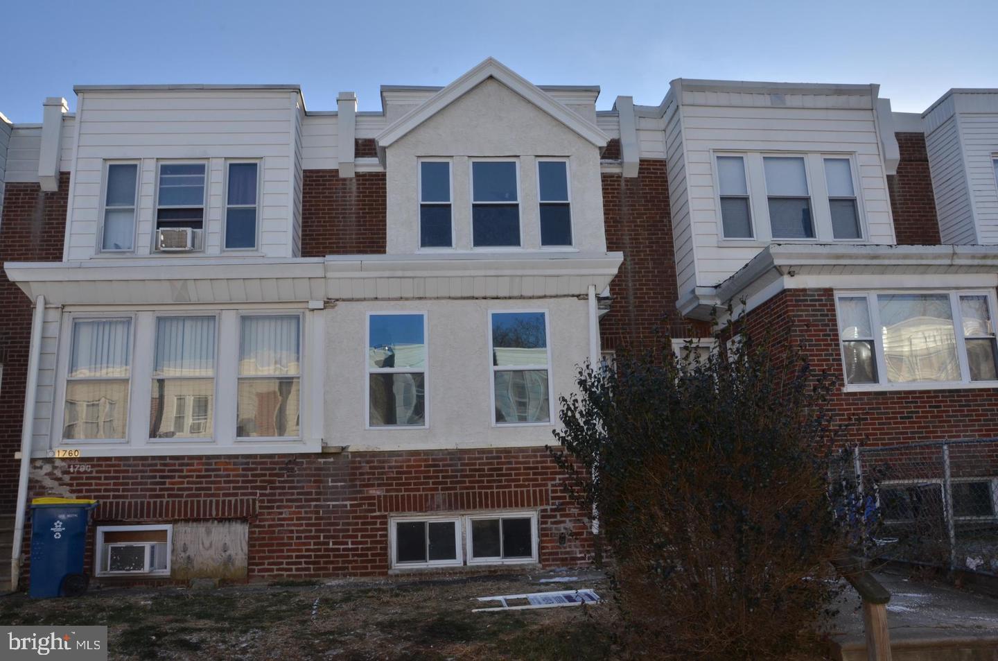 a view of a brick building next to a yard