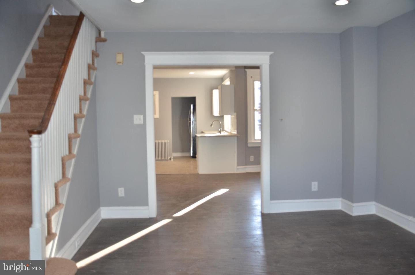 1758 South Avondale Street Philadelphia, PA 19142 - Photo 2 of 10 a view of a hallway with wooden floor and staircase