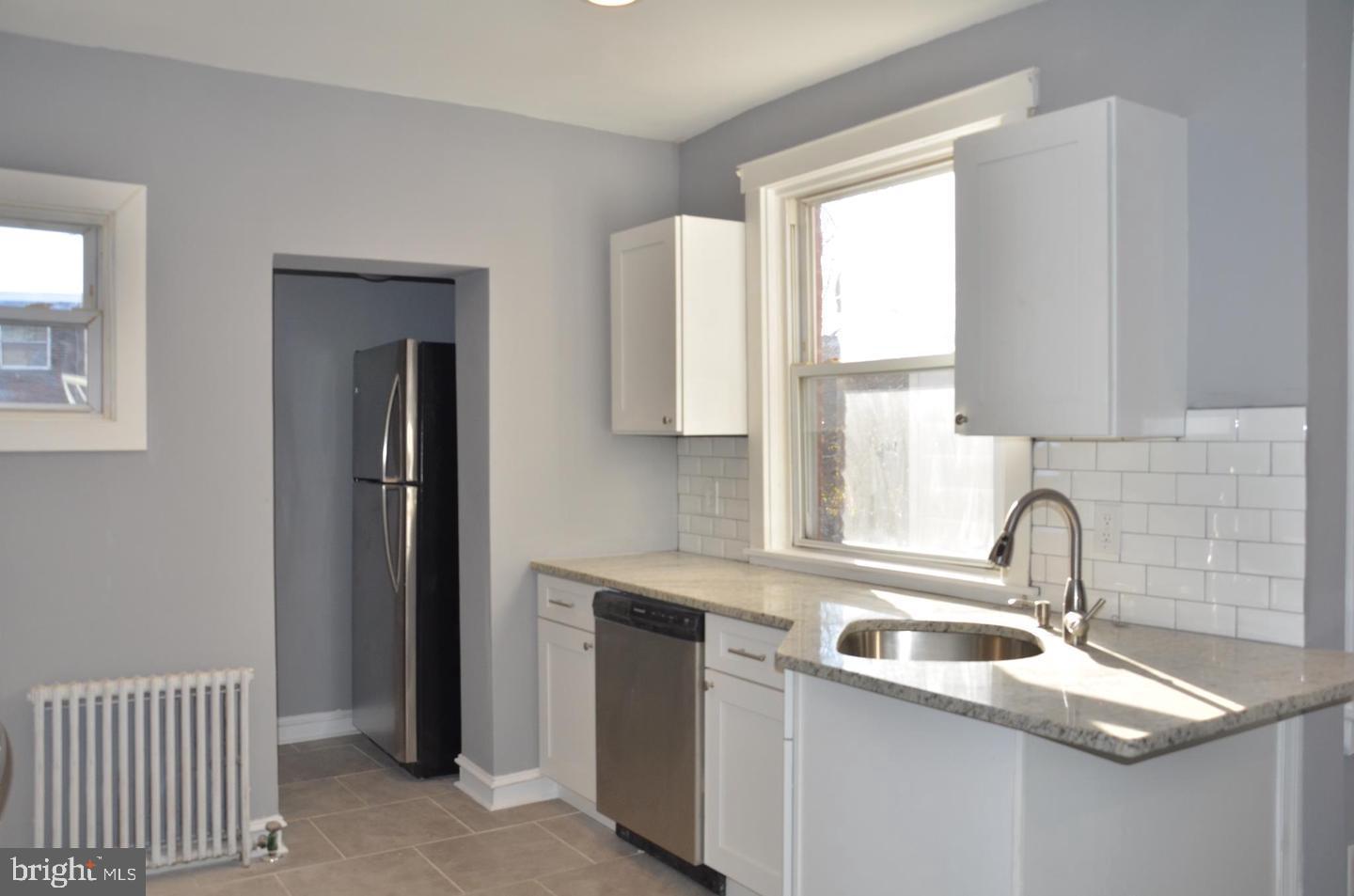 1758 South Avondale Street Philadelphia, PA 19142 - Photo 4 of 10 a kitchen with stainless steel appliances granite countertop a sink and a window