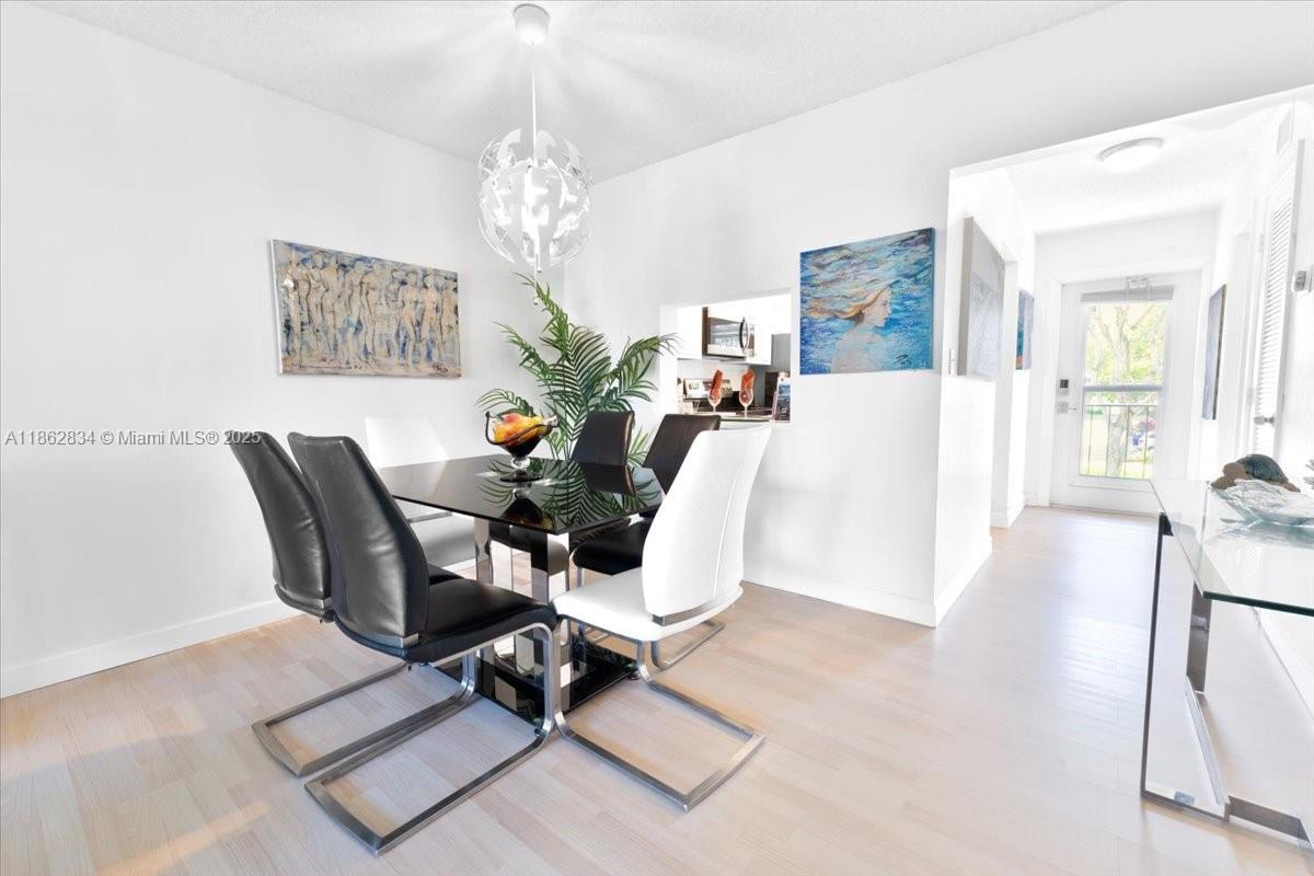 1501 South Ocean Boulevard, Unit 227 Lauderdale-by-the-Sea, FL 33062 - Photo 11 of 23 a living room with furniture a chandelier and a table
