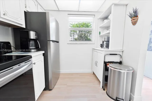 a kitchen with stainless steel appliances a refrigerator stove and microwave
