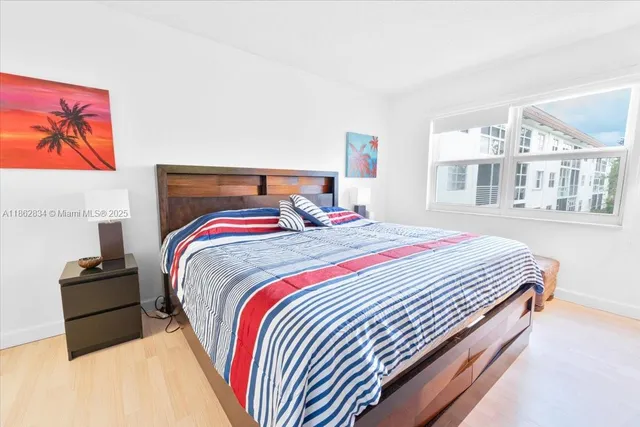 a bed sitting in a bedroom next to a window