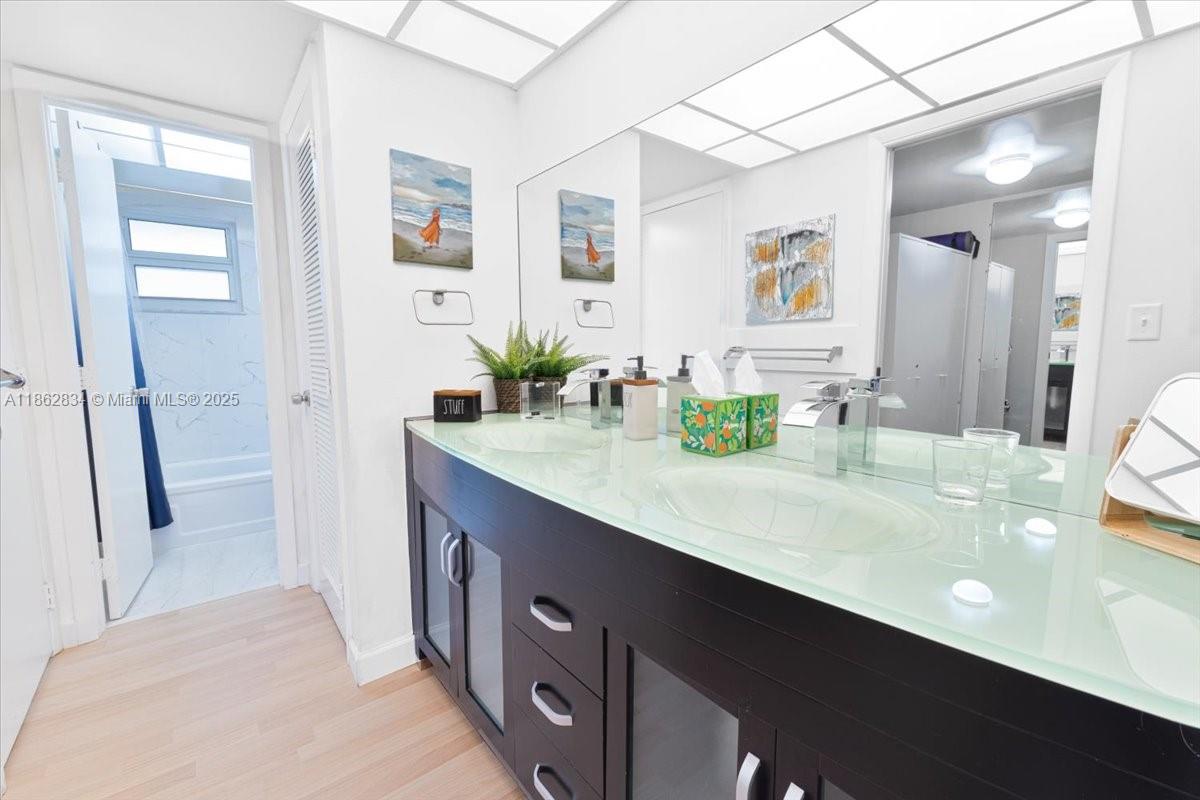 1501 South Ocean Boulevard, Unit 227 Lauderdale-by-the-Sea, FL 33062 - Photo 19 of 23 a bathroom with a double vanity sink mirror and shower