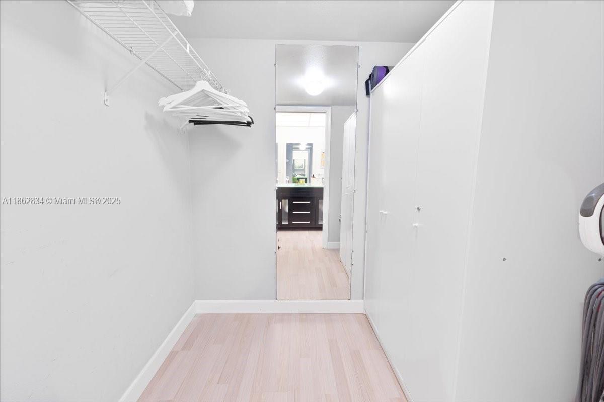 1501 South Ocean Boulevard, Unit 227 Lauderdale-by-the-Sea, FL 33062 - Photo 21 of 23 a view of a hallway with wooden floor and a bathroom