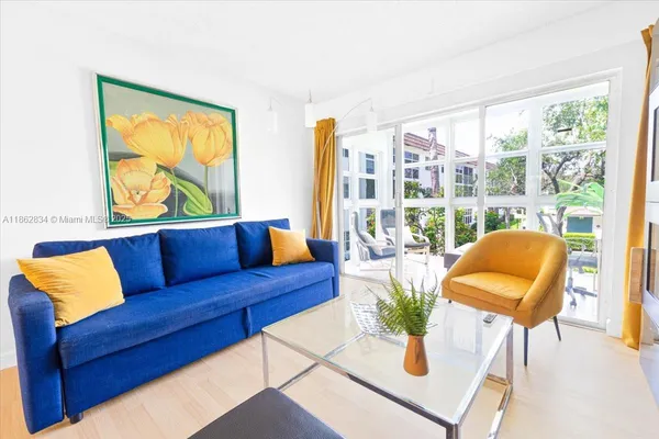 a living room with furniture and a large window