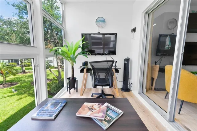 a living room with furniture and floor to ceiling windows